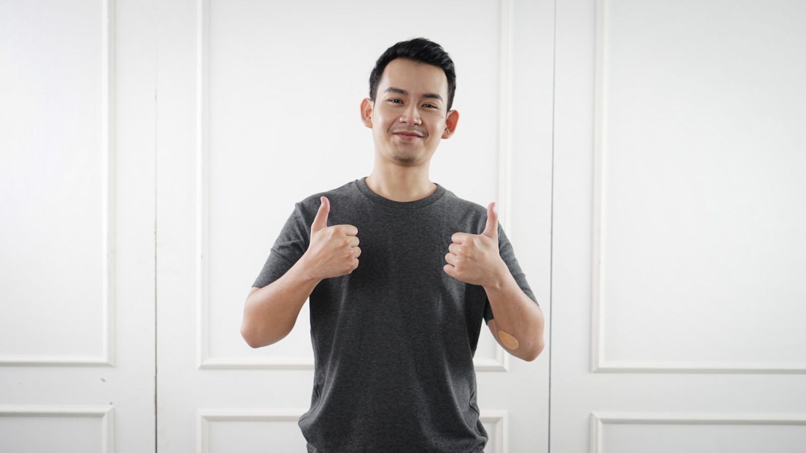 Man standing with a thumbs-up