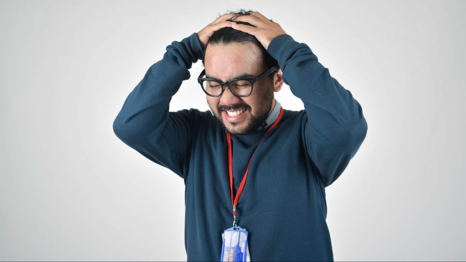 Stressed man holding his head