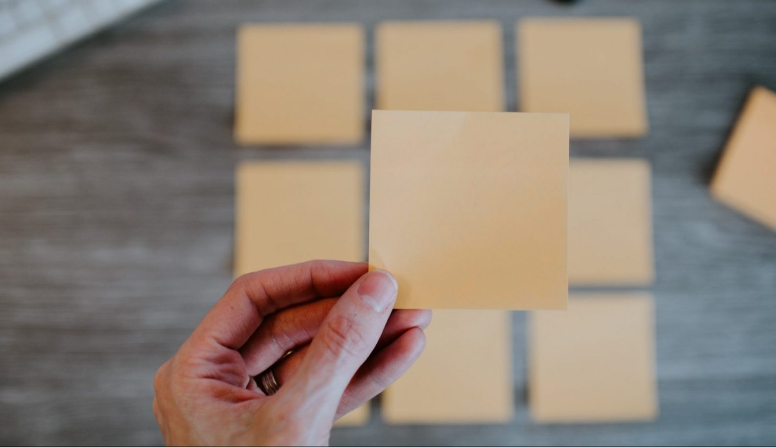 Person holding up a sticky notes