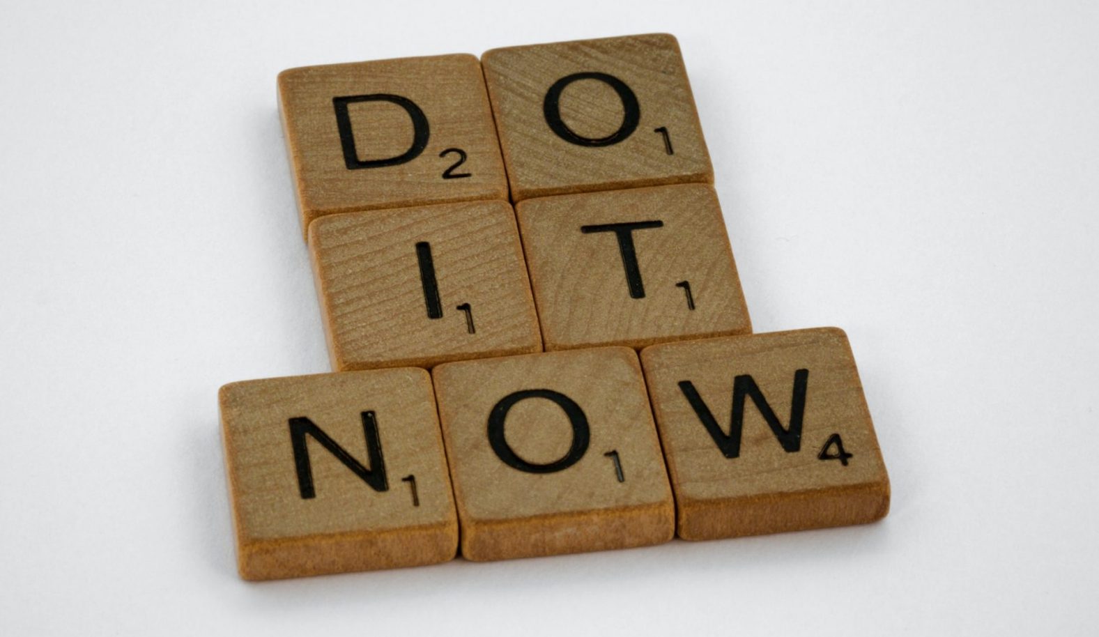 Brown wooden blocks saying "do it now"
