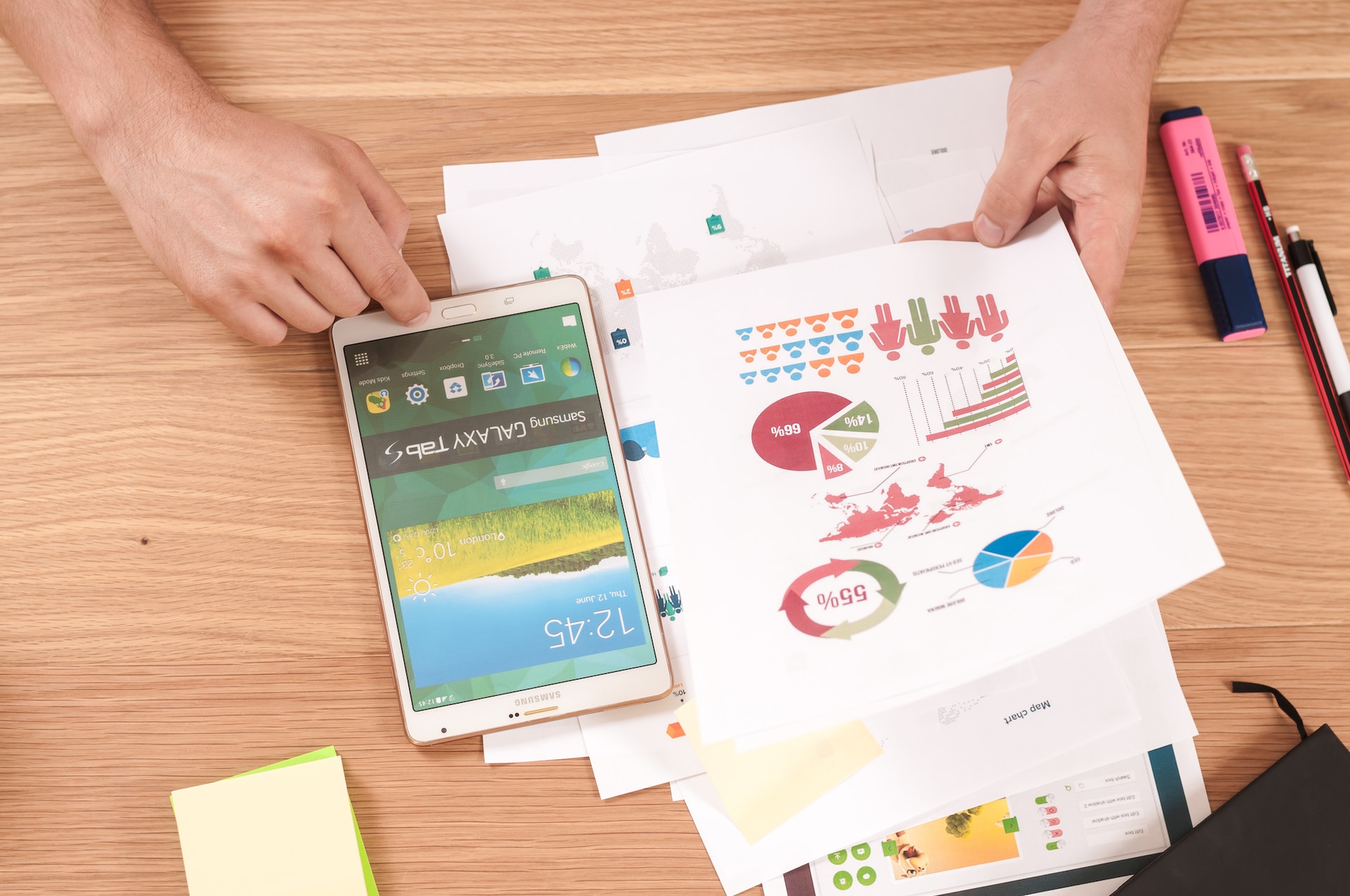 Person working with a pie chart and tablet