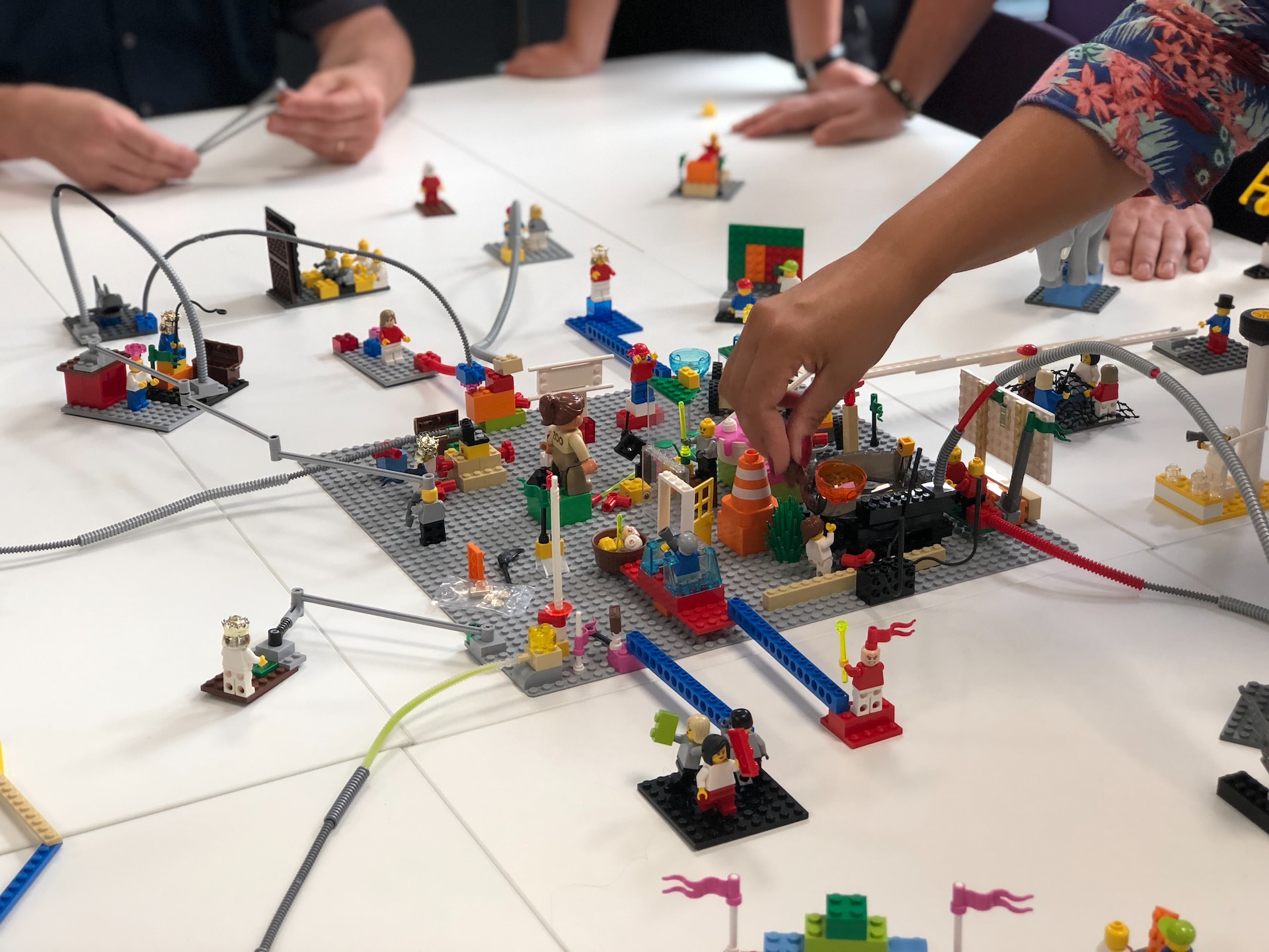 People playing with Lego on a flat surface