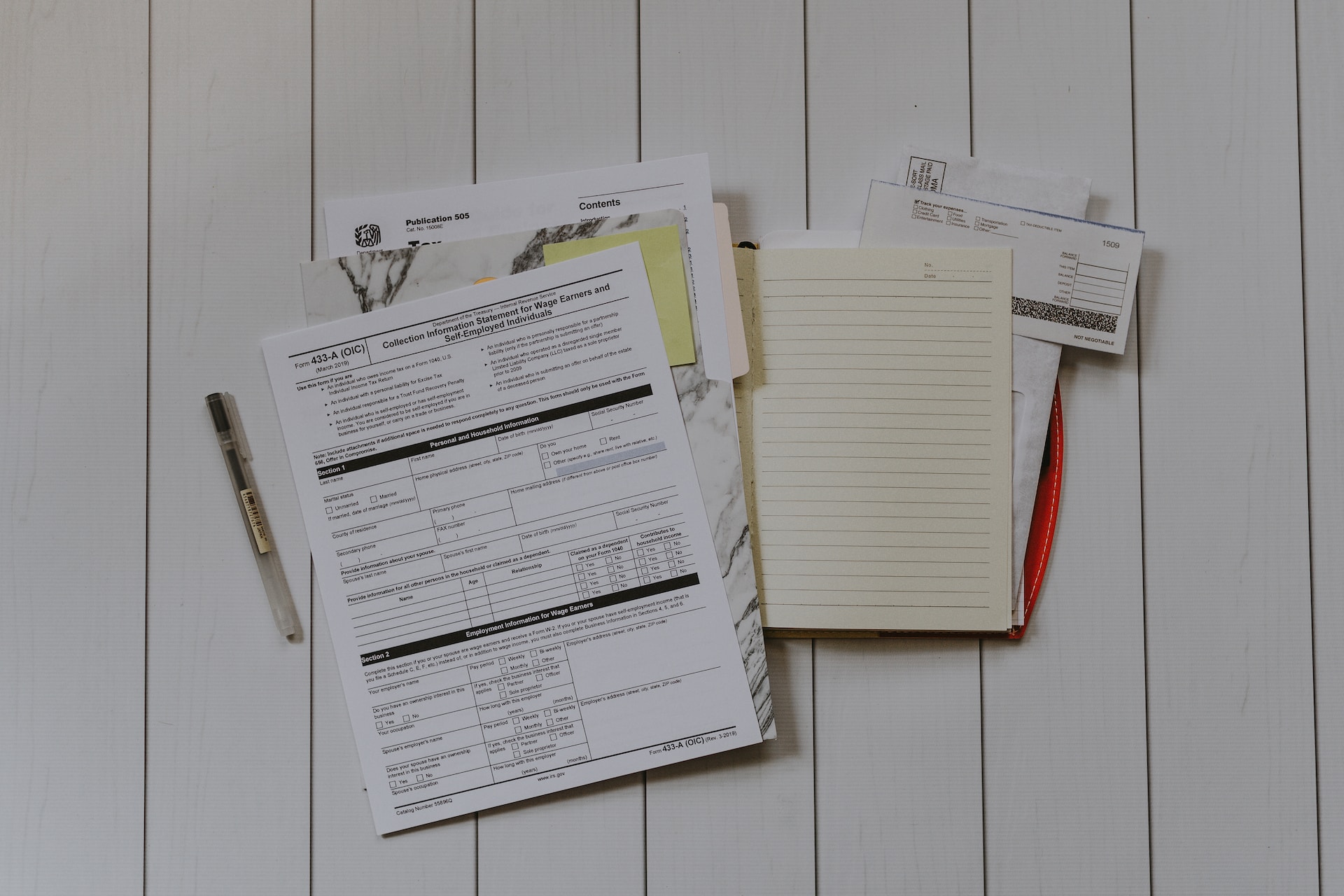 Audit documents and materials laying on a white table